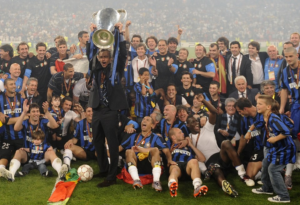 Inter Milan's Portuguese coach Jose Mourinho (C) celebrates with the trophy after winning the UEFA Champions League final football match Inter Milan against Bayern Munich at the Santiago Bernabeu stadium in Madrid on May 22, 2010. Inter Milan won the Champions League with a 2-0 victory over Bayern Munich in the final at the Santiago Bernabeu. Argentine striker Diego Milito scored both goals for Jose Mourinho's team who completed a treble of trophies this season. AFP PHOTO / PEDRO ARMESTRE (Photo credit should read PEDRO ARMESTRE/AFP/Getty Images)