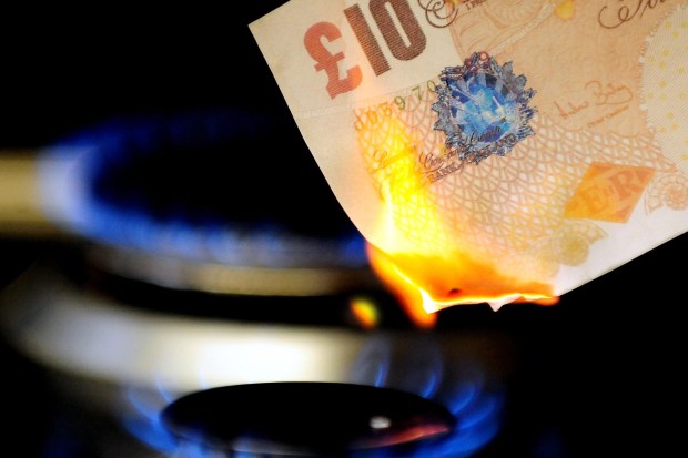 £10 note being burned by a gas flame