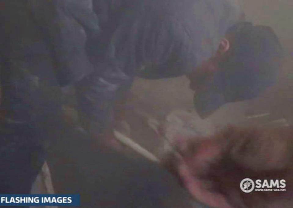 The cameraman enters the bombed building amid loud screams for help