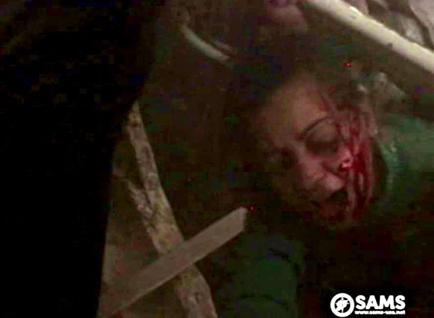A crushed woman thought to be the man's aunt screeches in agony next to a little boy