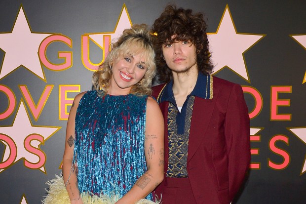 Miley Cyrus and Maximo Riviera posing together.