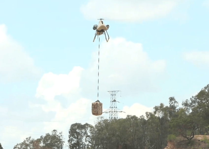 The drone helicopter lifts a heavy load to be transported to the frontline