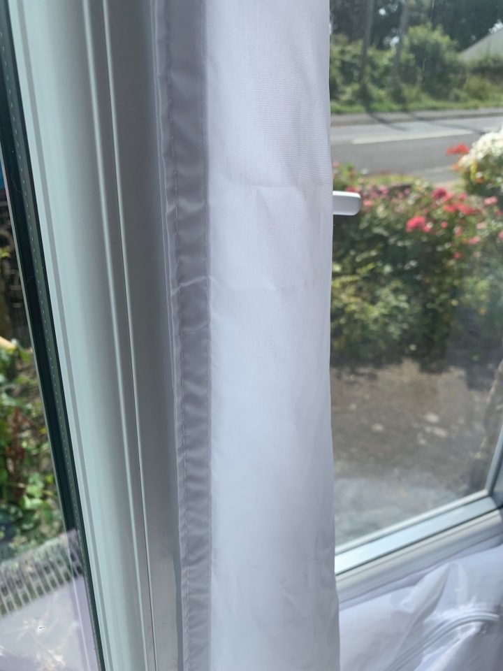 Close-up of a white window curtain.