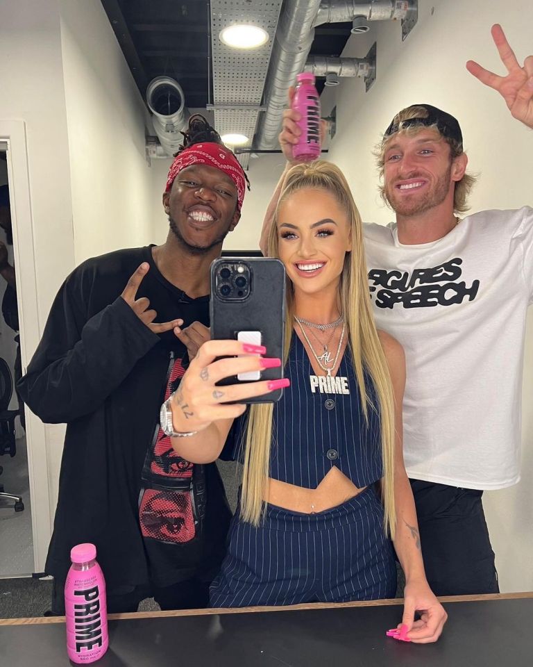 three people posing for a picture with one wearing a shirt that says prime