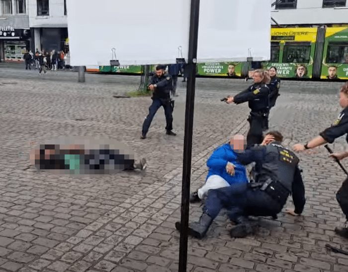 A cop shoots the knifeman after he stabs an officer in the back