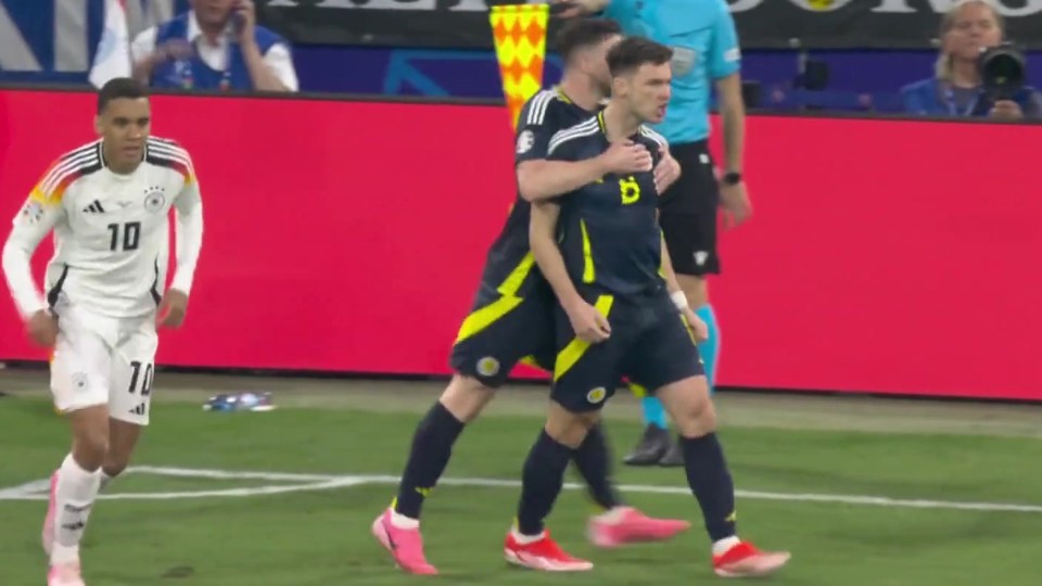 Andrew Robertson and Kieran Tierney celebrate winning a goal kick