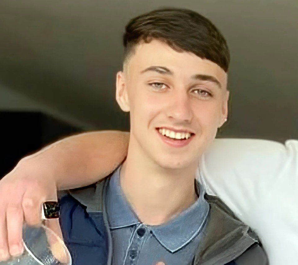 a young man wearing a berghaus vest is holding a glass of water