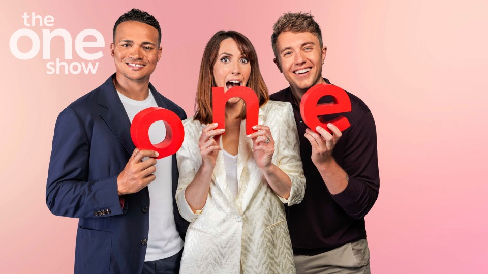 a group of people holding up the word one