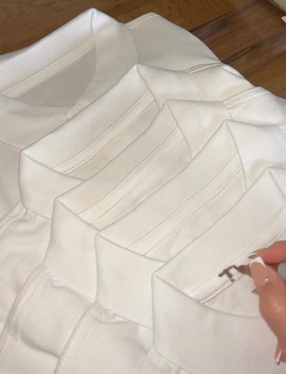 a stack of white shirts with a tag that says 60 on it