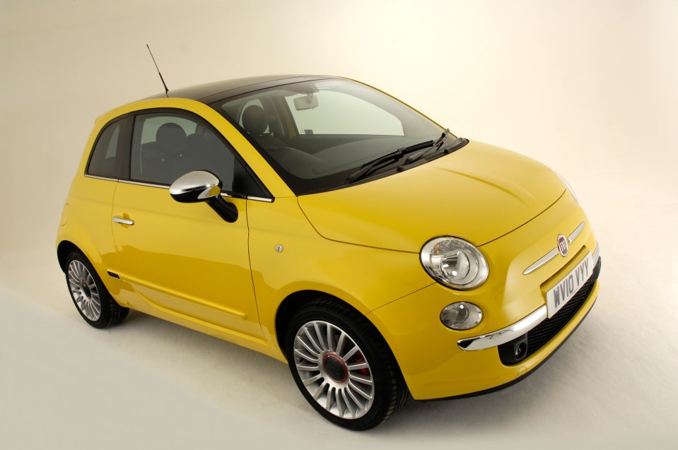 a yellow fiat 500 with a black roof