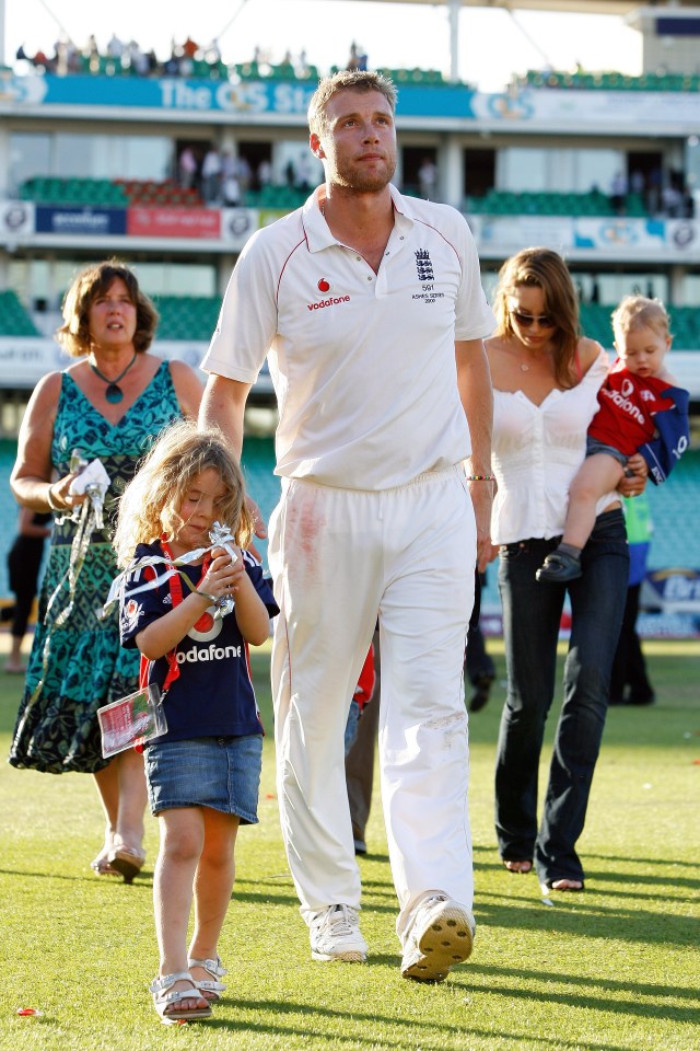 a man wearing a white vodafone shirt walks with his family