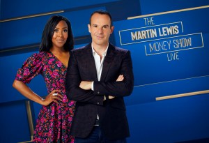 a man and a woman are standing in front of a sign that says the martin lewis money show live