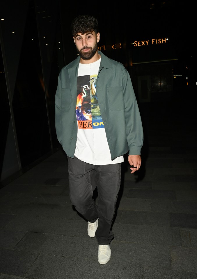 a man wearing a shirt that says heron on it