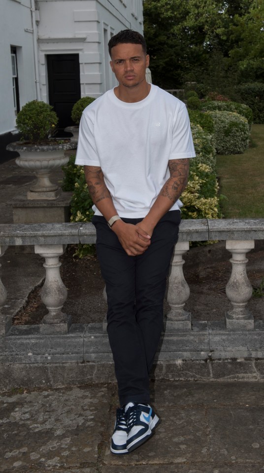 a man wearing a white t-shirt and black pants
