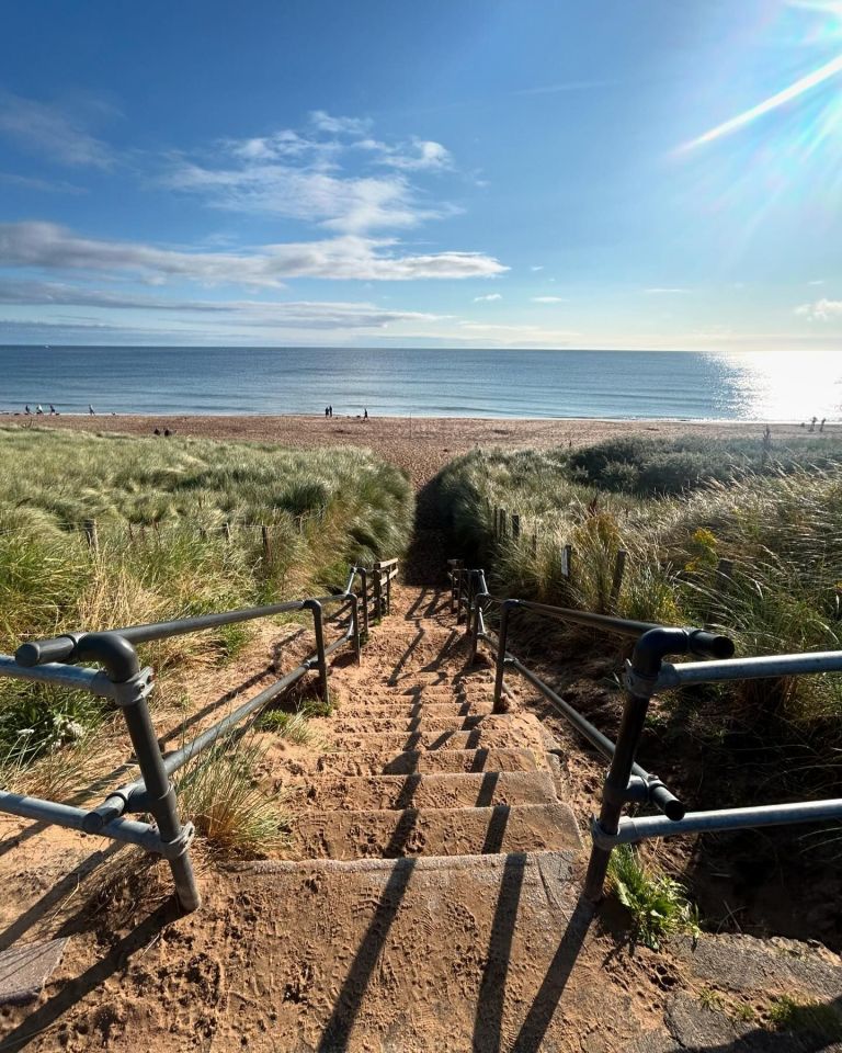 a set of stairs leading up to a beach