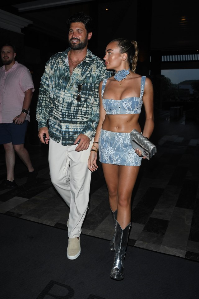 a man and a woman are walking down a street