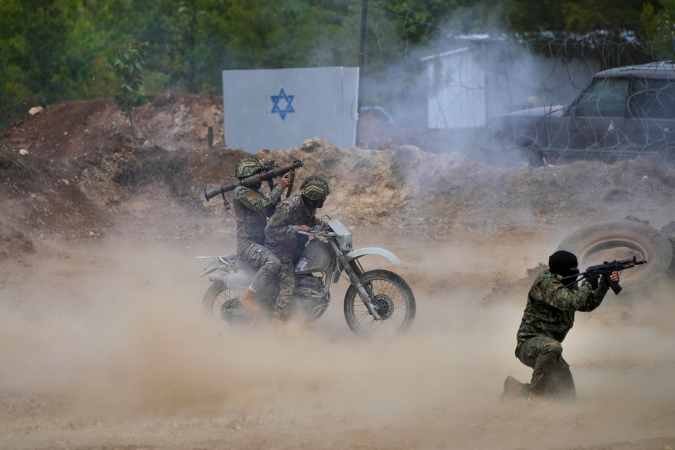 two soldiers are riding a motorcycle with a star of david on the side