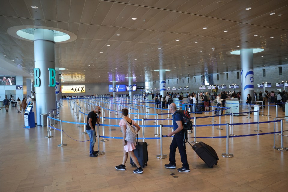 people waiting at a check in line at an airport with a sign that says b