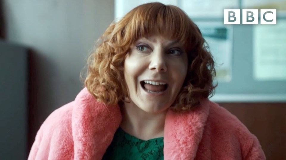a woman wearing a pink fur coat with bbc written on the bottom