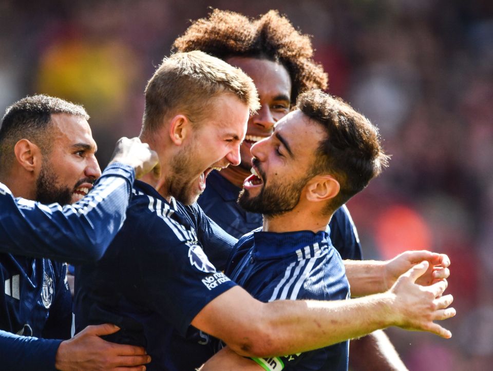 a group of soccer players are celebrating a goal