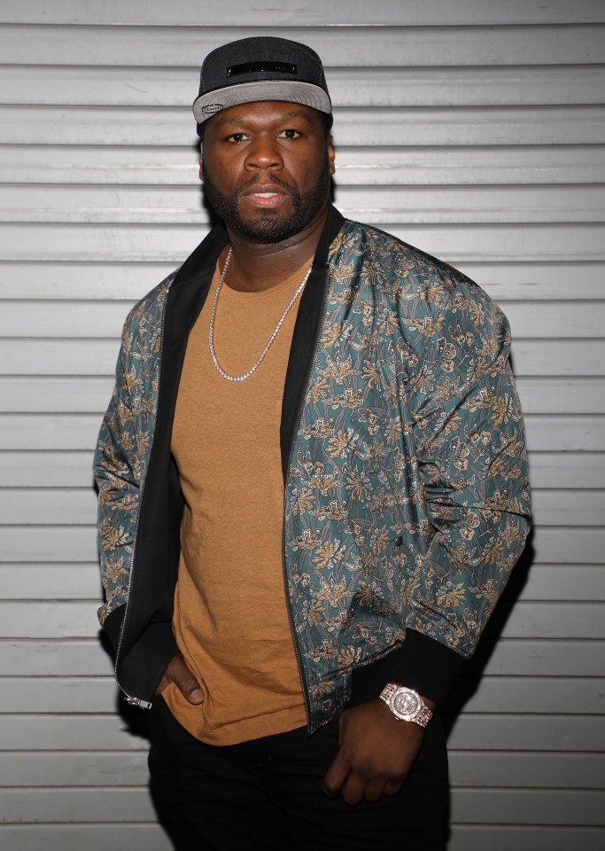 a man wearing a hat and a jacket has a watch on his wrist