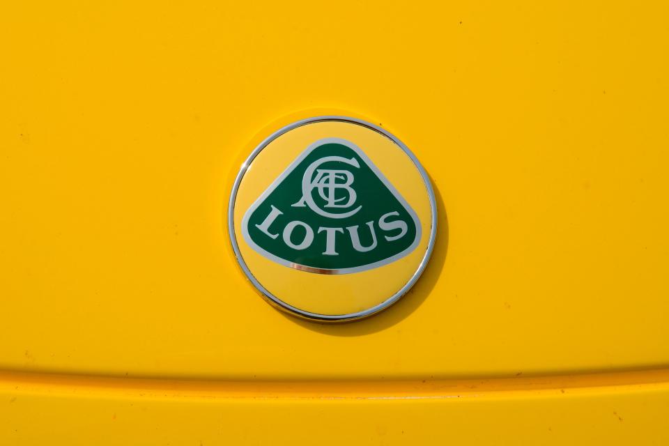 a yellow car with a green lotus logo on it