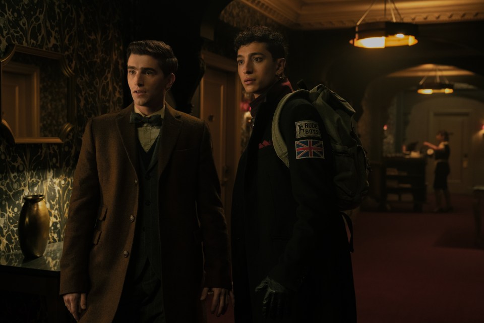 two men standing in a hallway with one wearing a backpack that says british expedition