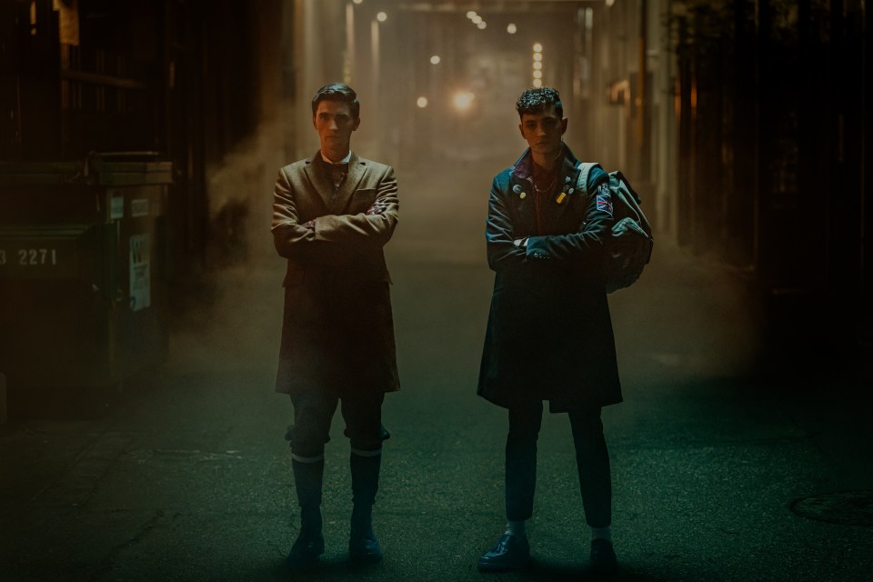 two men standing next to each other in a dark alleyway with the number 2277 in the background