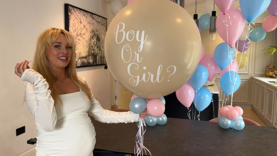 a woman holding a balloon that says boy or girl