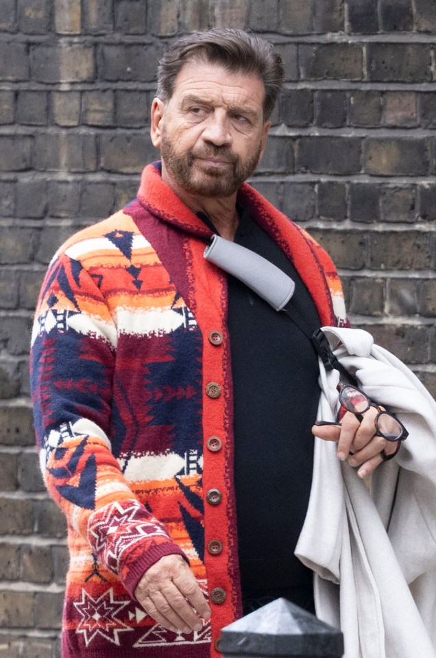 a man wearing a colorful sweater with buttons on it