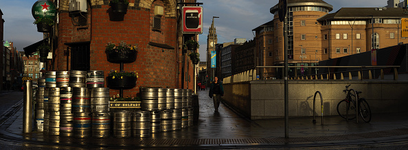 a row of kegs are lined up in front of a sign that says the irish railroad