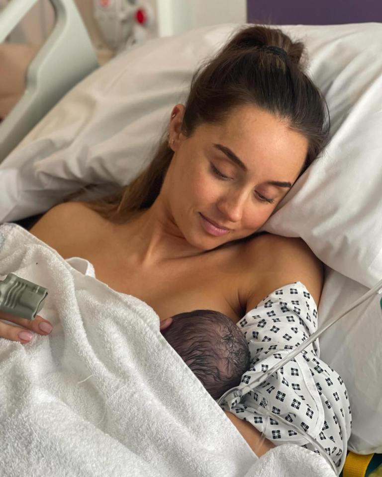 a woman is holding a newborn baby in a hospital bed