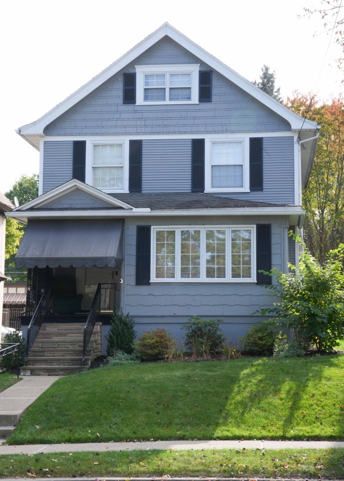 a blue house with white trim and black shutters