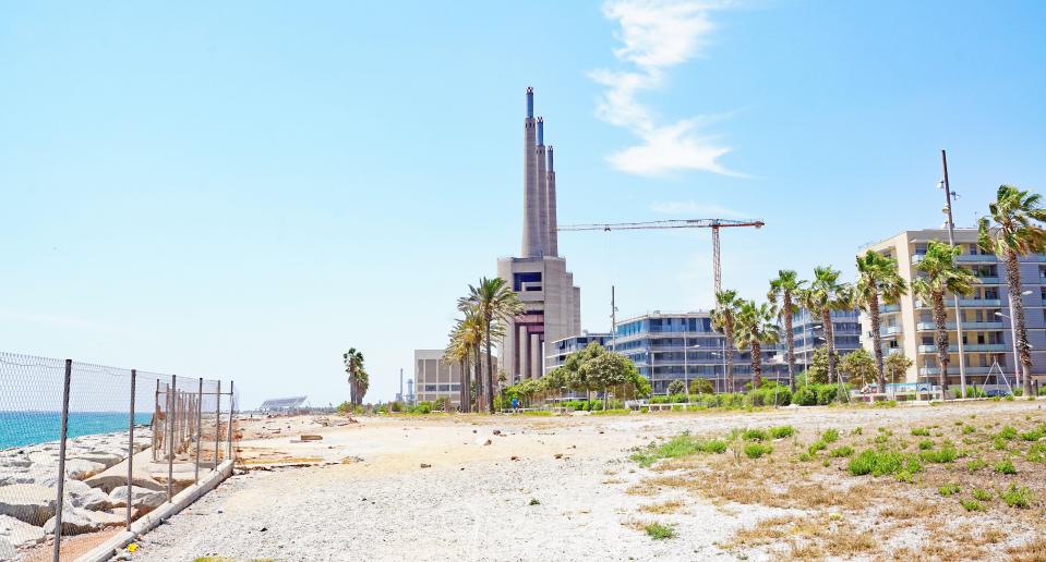 a large building is being built next to the ocean