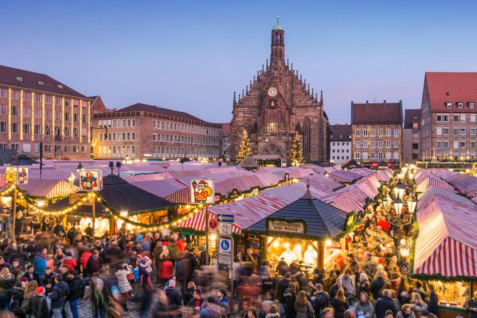 a crowd of people are gathered at a christmas market