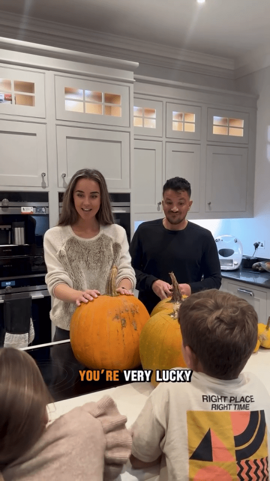 a man and a woman standing in a kitchen with pumpkins and a caption that says you 're very lucky