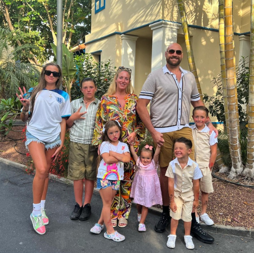 a family poses for a picture in front of a building