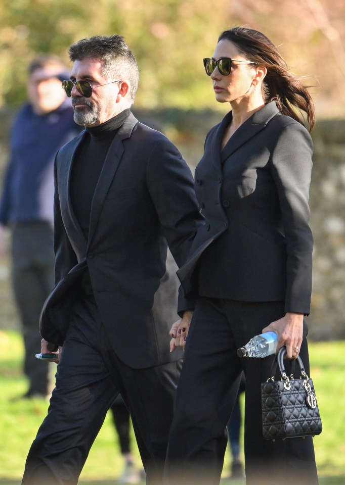 a man and a woman are holding hands while walking