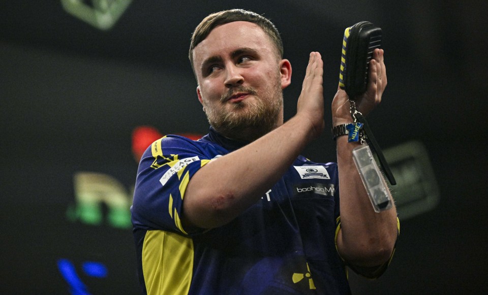 a man in a blue and yellow shirt with a badge on his arm that says ' bwin ' on it