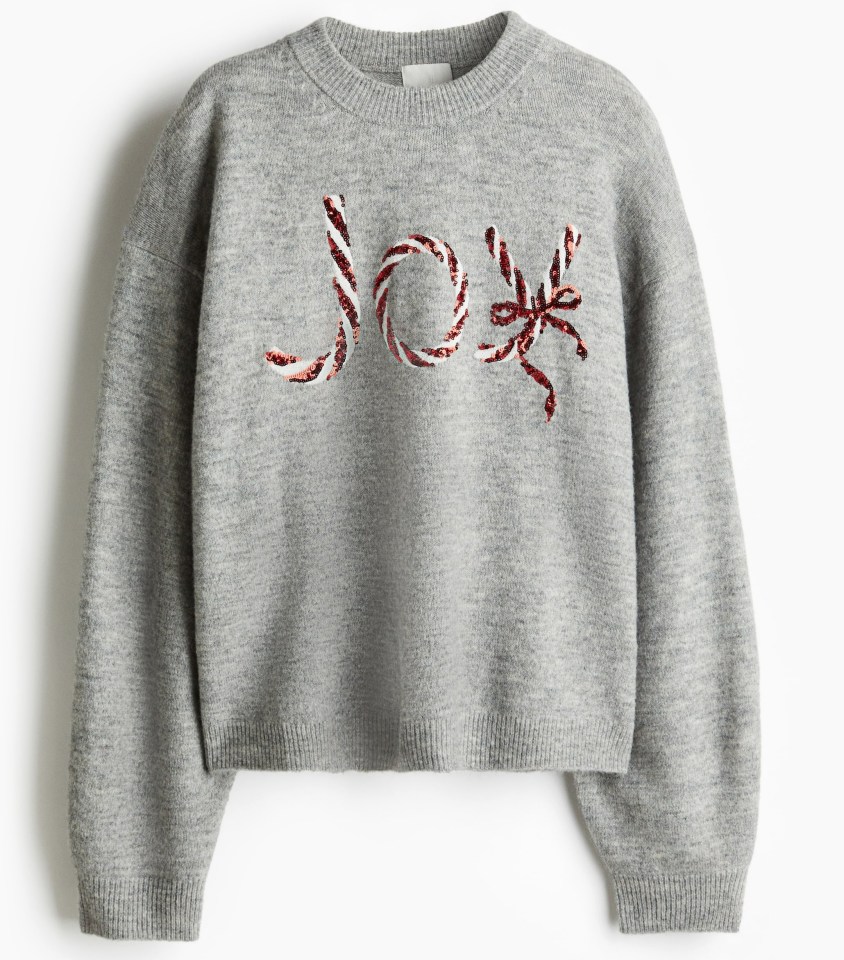 a grey sweater with the word joy on it