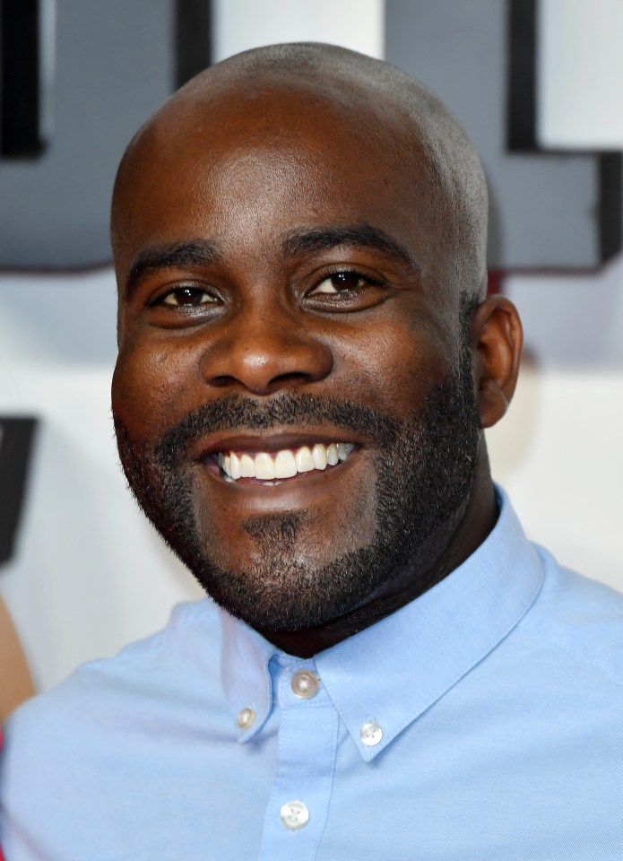 a bald man with a beard is smiling for the camera