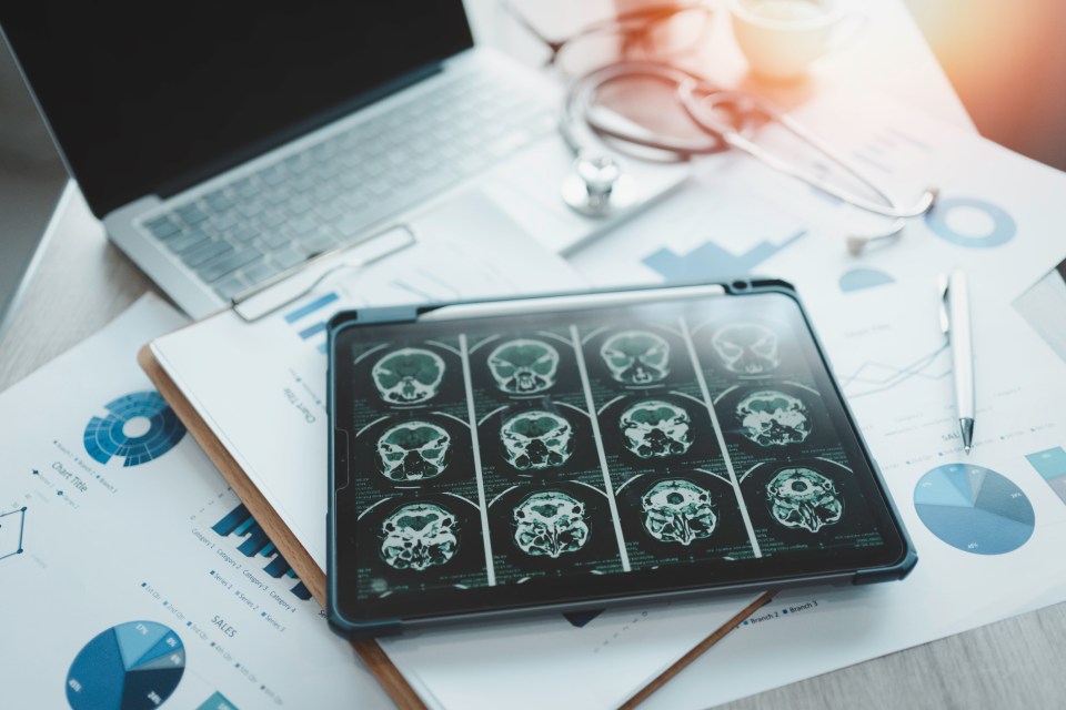 a tablet with a picture of a brain on it