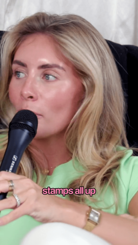 a woman in a green shirt is holding a sennheiser microphone