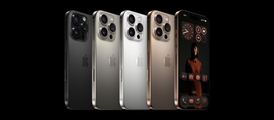 a row of iphones are lined up against a black background