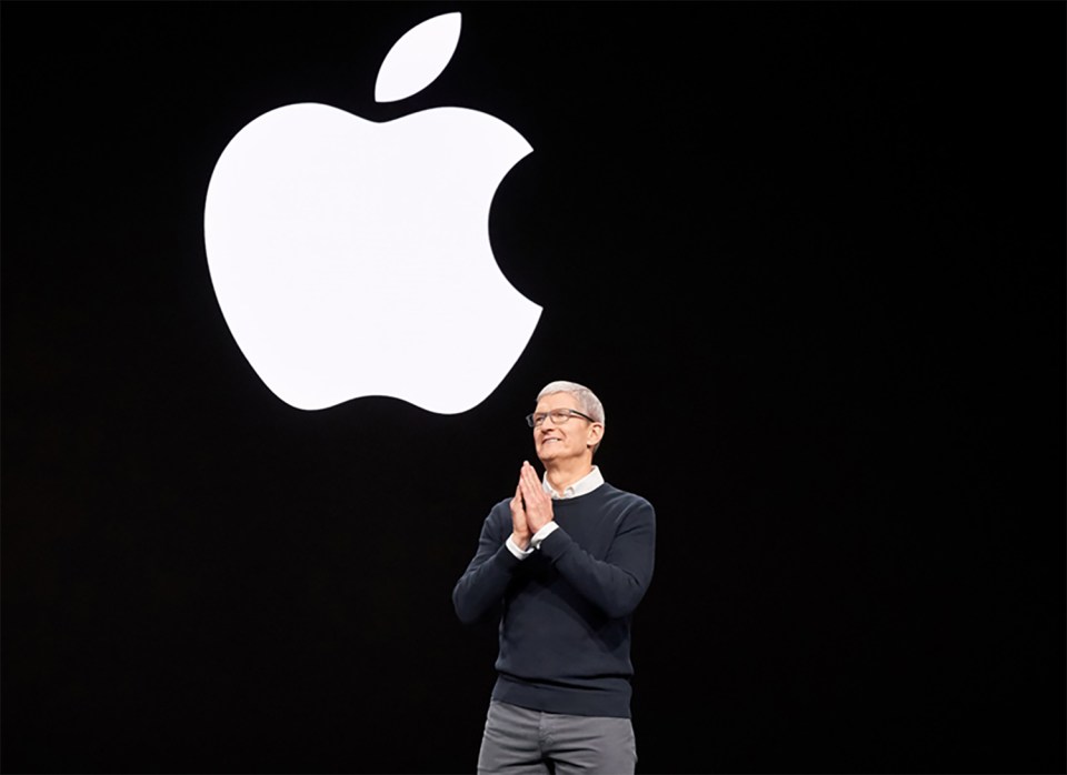 a man stands in front of an apple logo