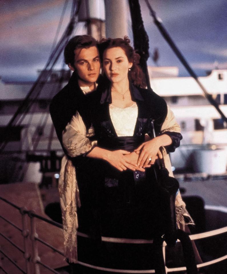 a man and a woman standing next to each other on a boat