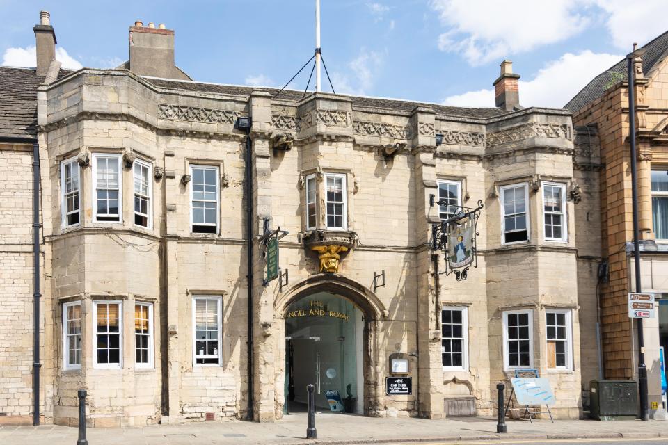 a stone building with a sign that says the castle and crown