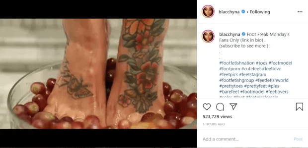 Blac Chyna's tattooed feet in a bowl of grapes.