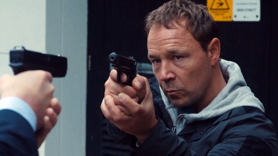 A man aims a gun at another man holding a gun.