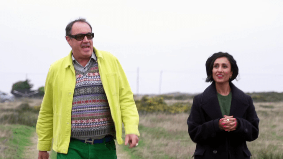 Two people walking in a field.